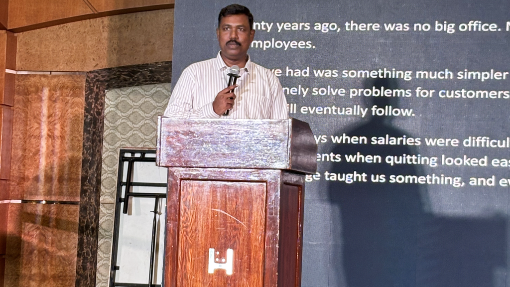 Mr. Rajarajan Anbalagan, Managing Director of Tridots Tech, speaking during the 20th Anniversary Celebration.